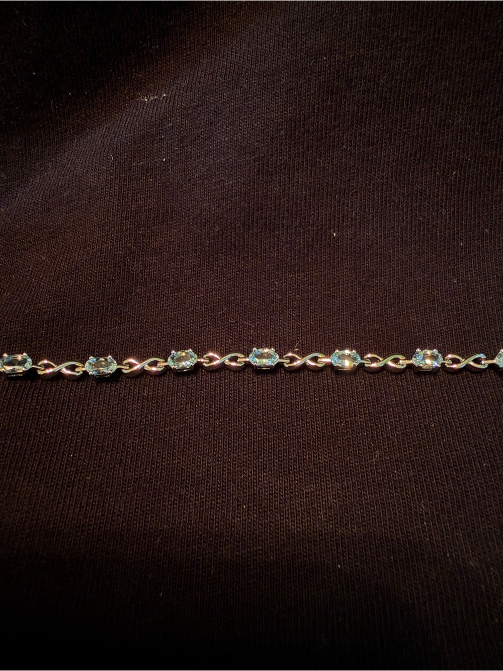 Sterling Silver Tennis Bracelet with Light Blue Stones and Infinity Shaped Links